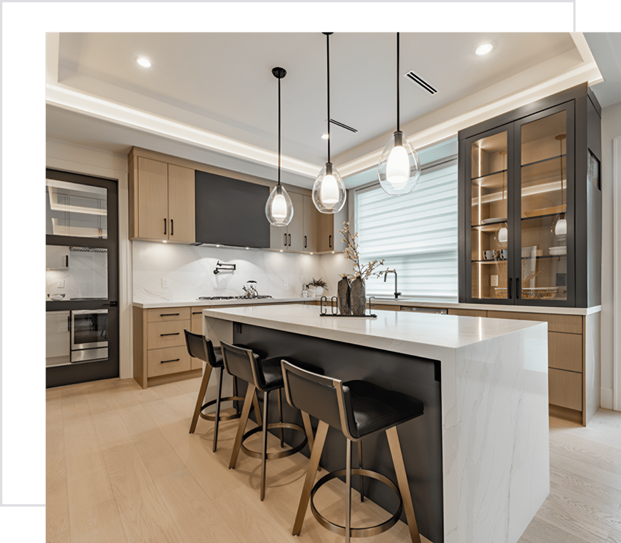 Modern kitchen with island and pendant lights.