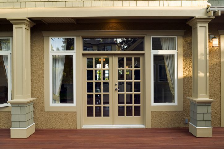 Glass-paneled door with surrounding windows.