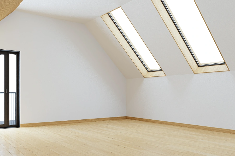 Minimalist room with skylights and wooden floor.