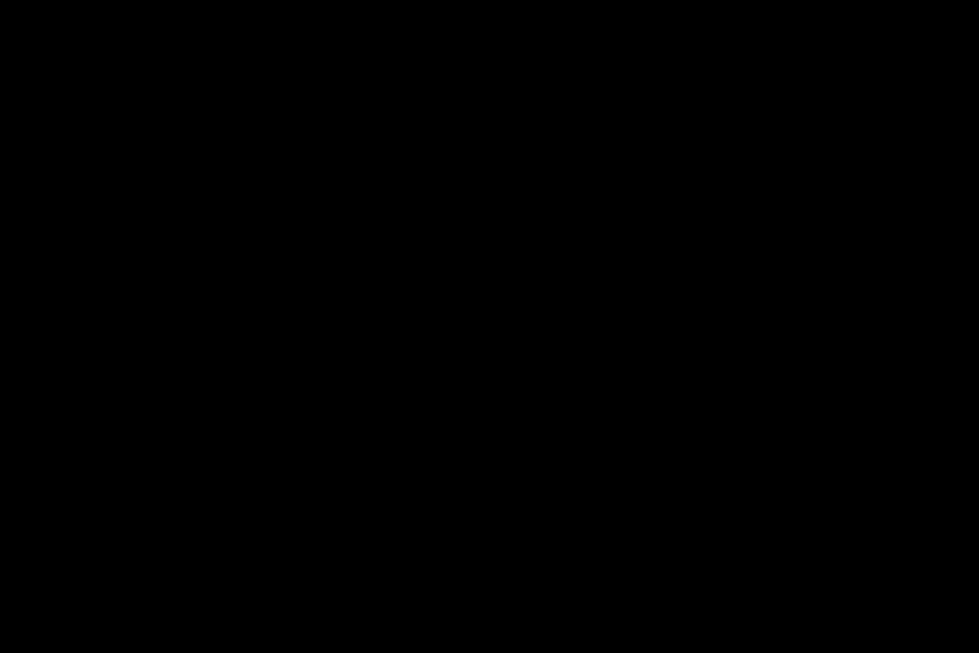 Silhouette of a person playing electric guitar.