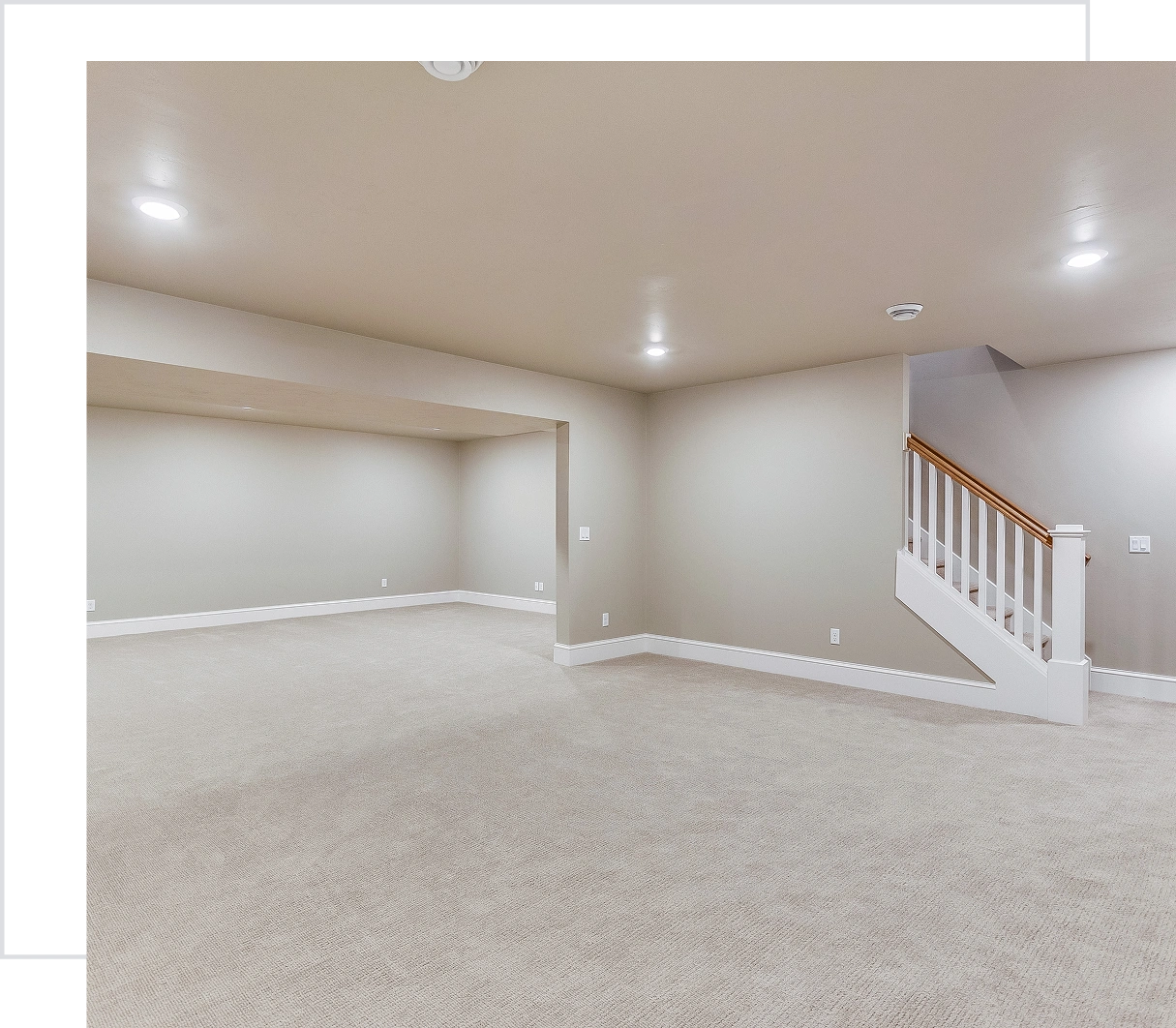 Empty basement with carpet and stairs.