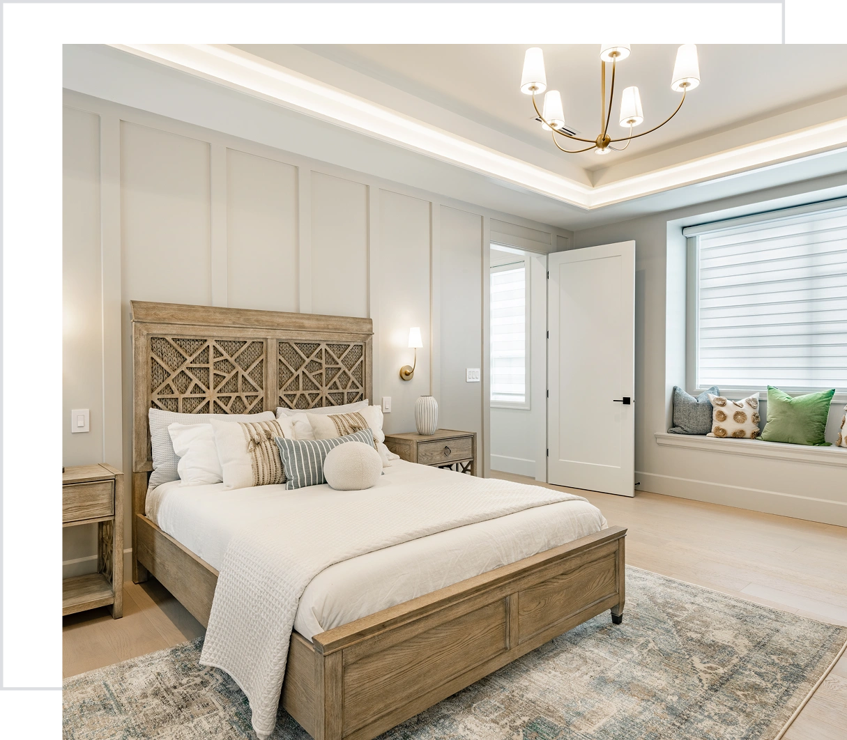 Modern bedroom with wooden bed and chandelier.