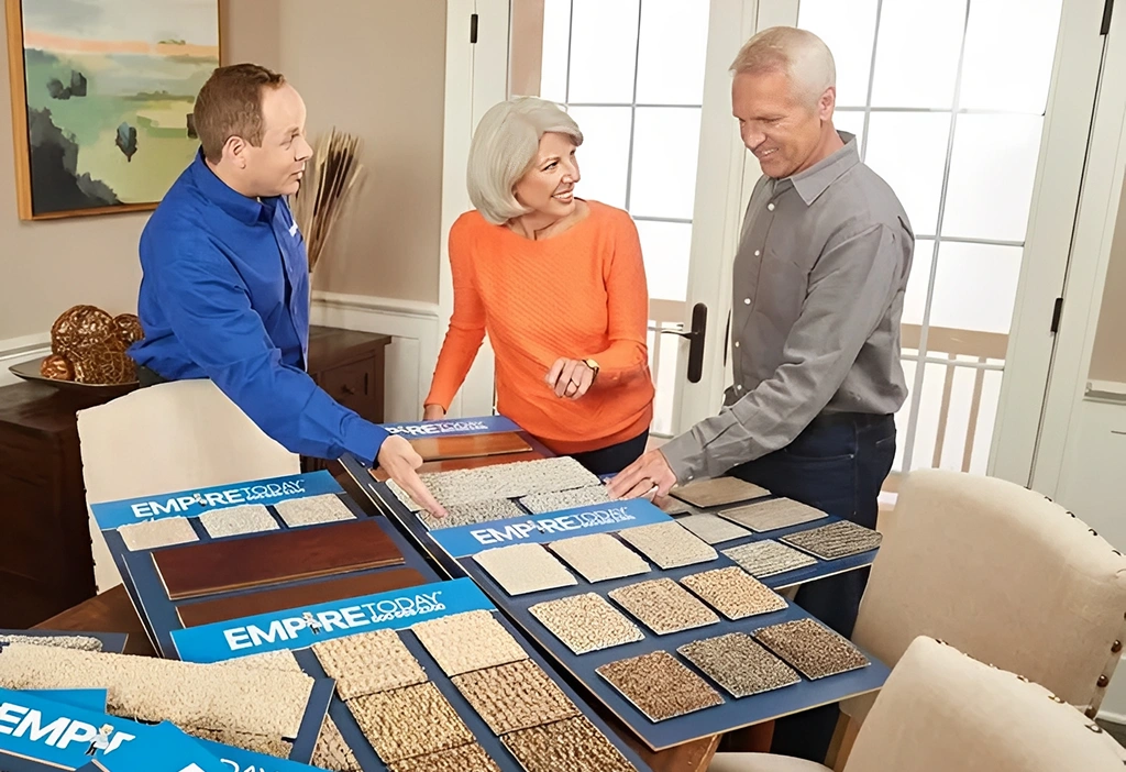 People choosing carpet samples in living room.