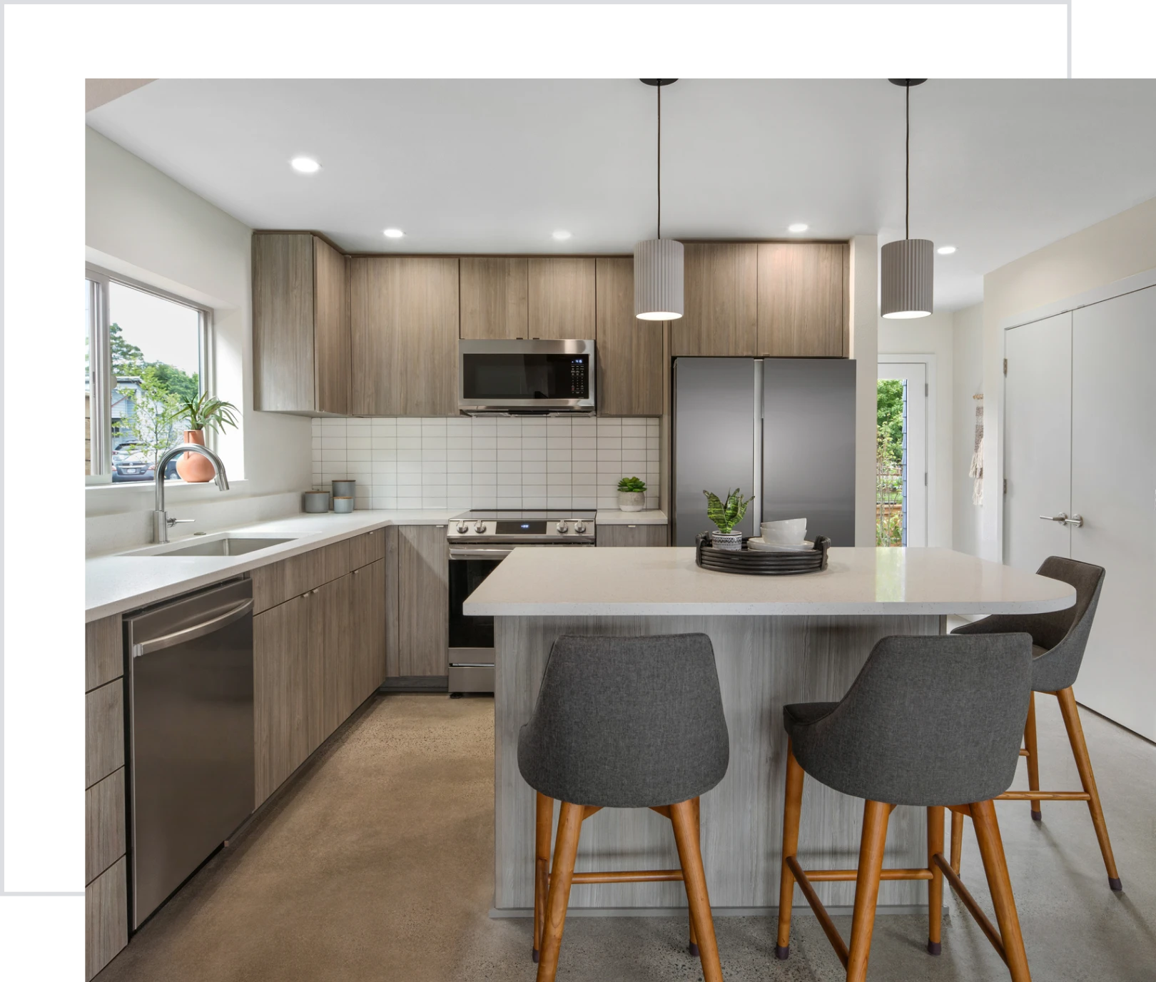 Modern kitchen with island and bar stools.