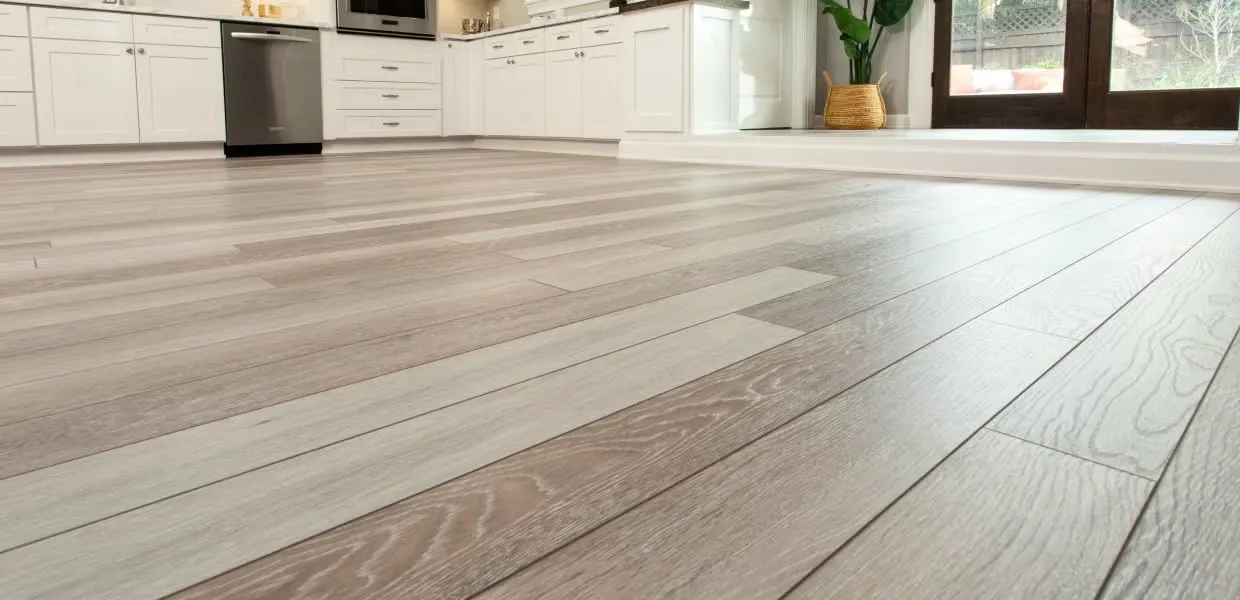 Modern kitchen with light wood flooring.