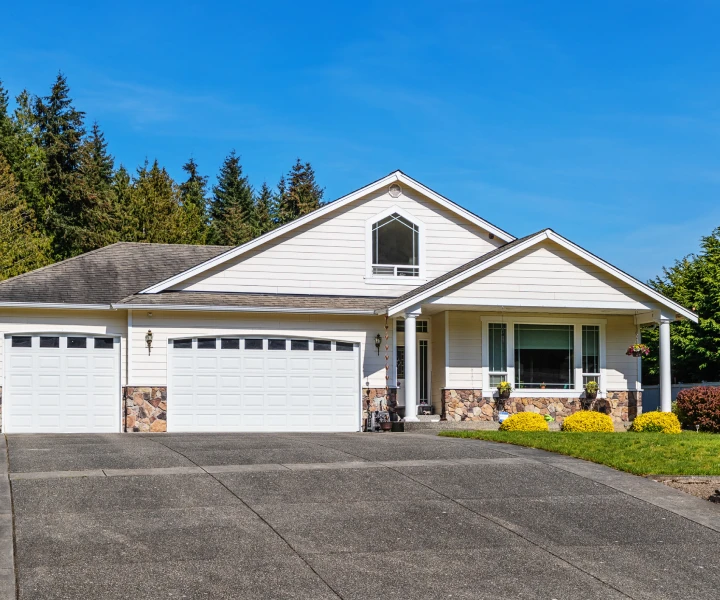 White suburban house with two-car garage.