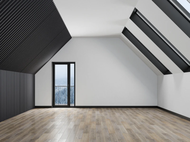 Modern attic room with large windows.