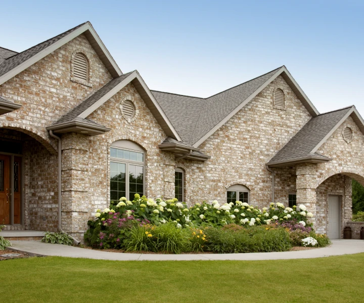 Brick house with landscaped garden and lawn.