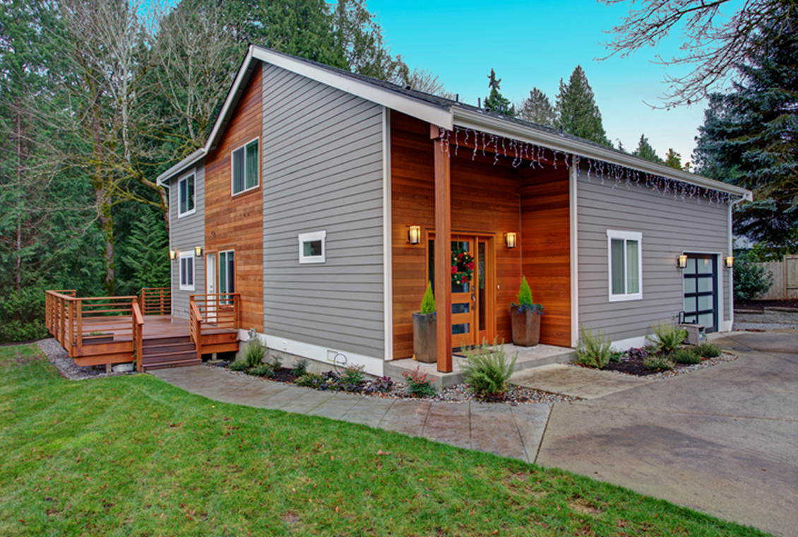 Modern two-story house with wooden siding.
