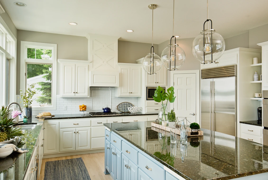 Modern kitchen with white cabinets and island.