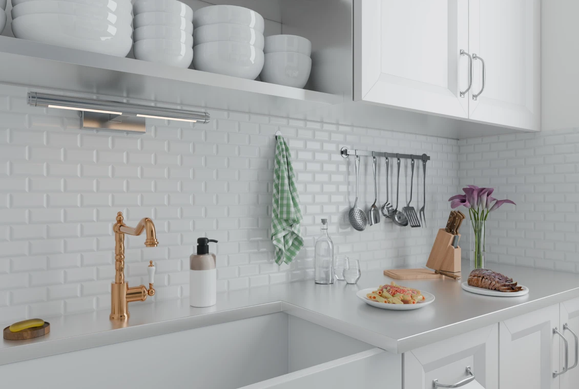 Modern kitchen countertop with utensils and decor.