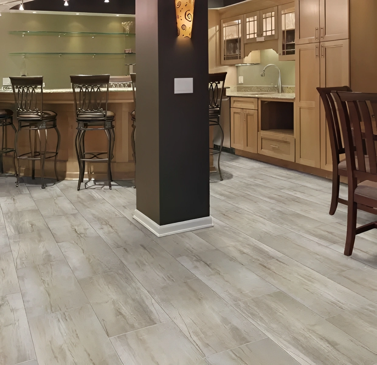 Modern kitchen with wooden cabinets and bar stools.