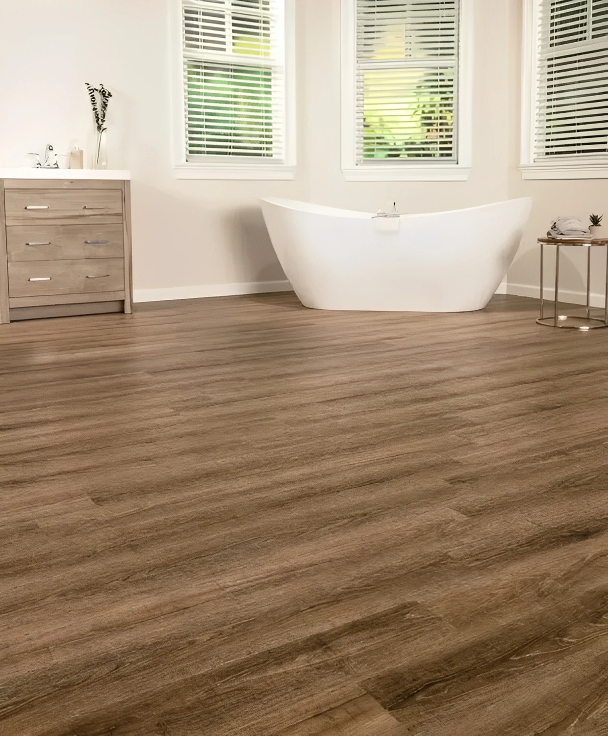 Bathroom with wooden floor and white bathtub.