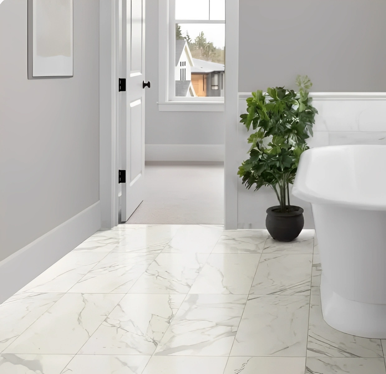 Modern bathroom with plant and marble floor.