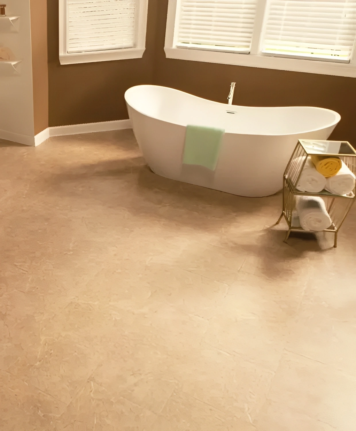 Modern bathroom with freestanding bathtub and towels.